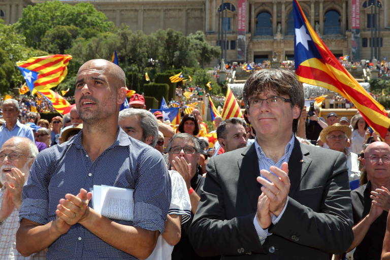 Pep Guardiola y Carles Puigdemont, en un acto independentista el pasado 11 de junio. Foto: EFE